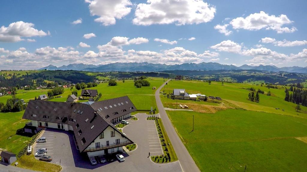 an aerial view of a house in a field at Hotel Bachledówka in Zakopane