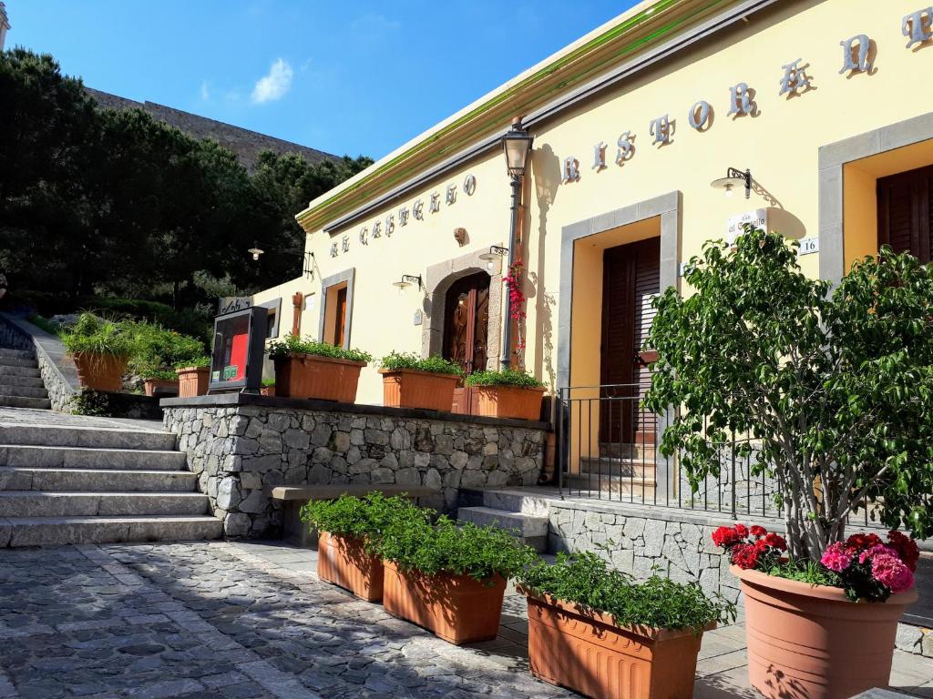 a building with potted plants in front of it at Al Castello in Milazzo