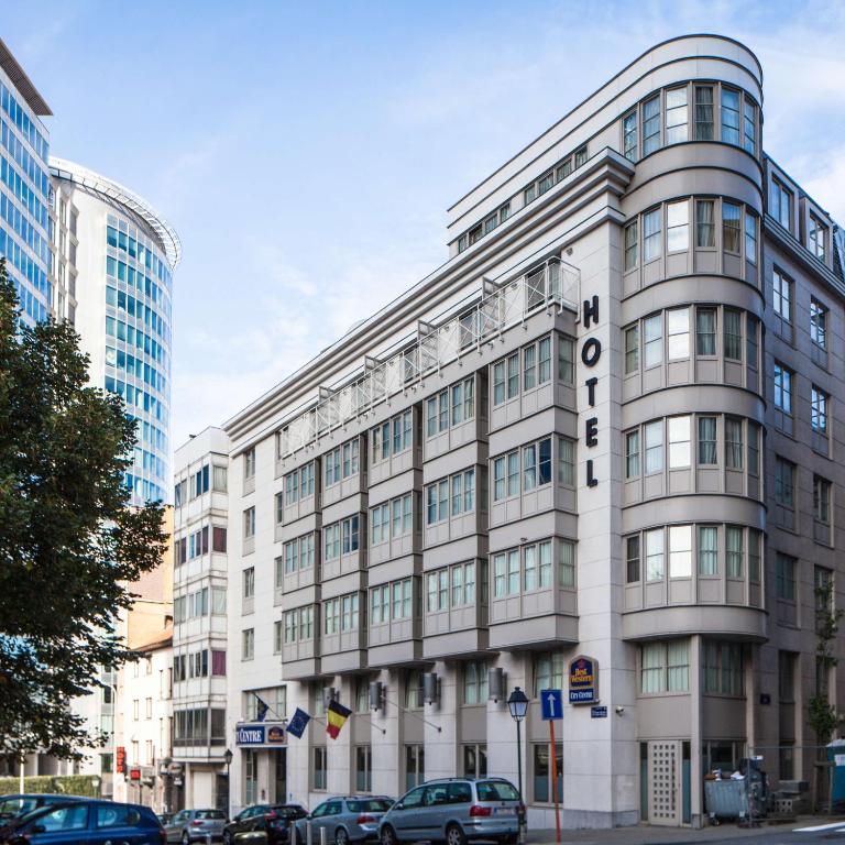 a large white building with a sign on it at Hotel Best Western City Centre in Brussels