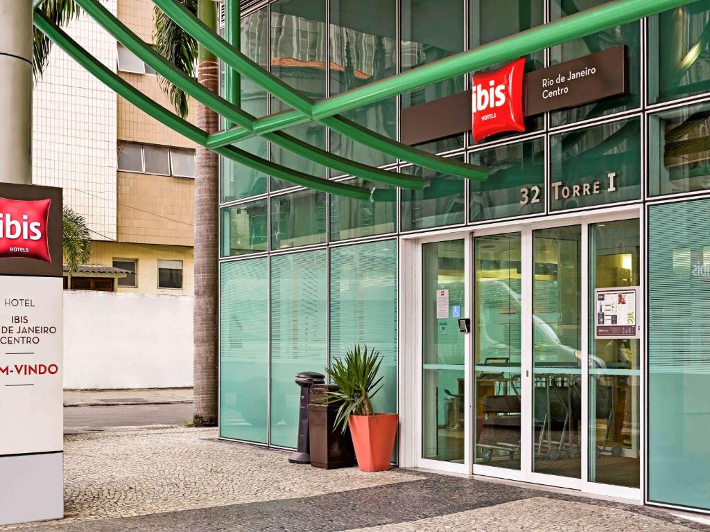 ibis Rio de Janeiro Centro في ريو دي جانيرو: مبنى بأبواب زجاجية ونصب الفخار في الأمام