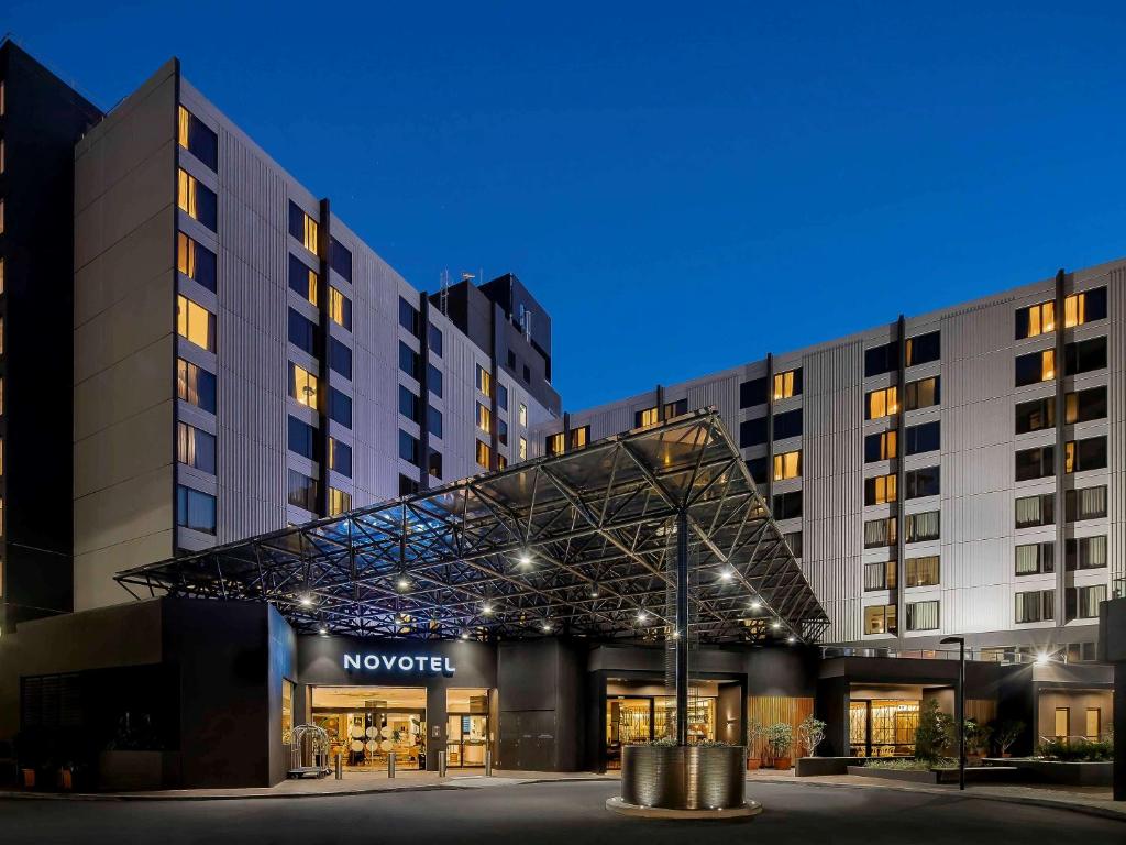 a view of the novotel hotel at night at Novotel Sydney International Airport in Sydney