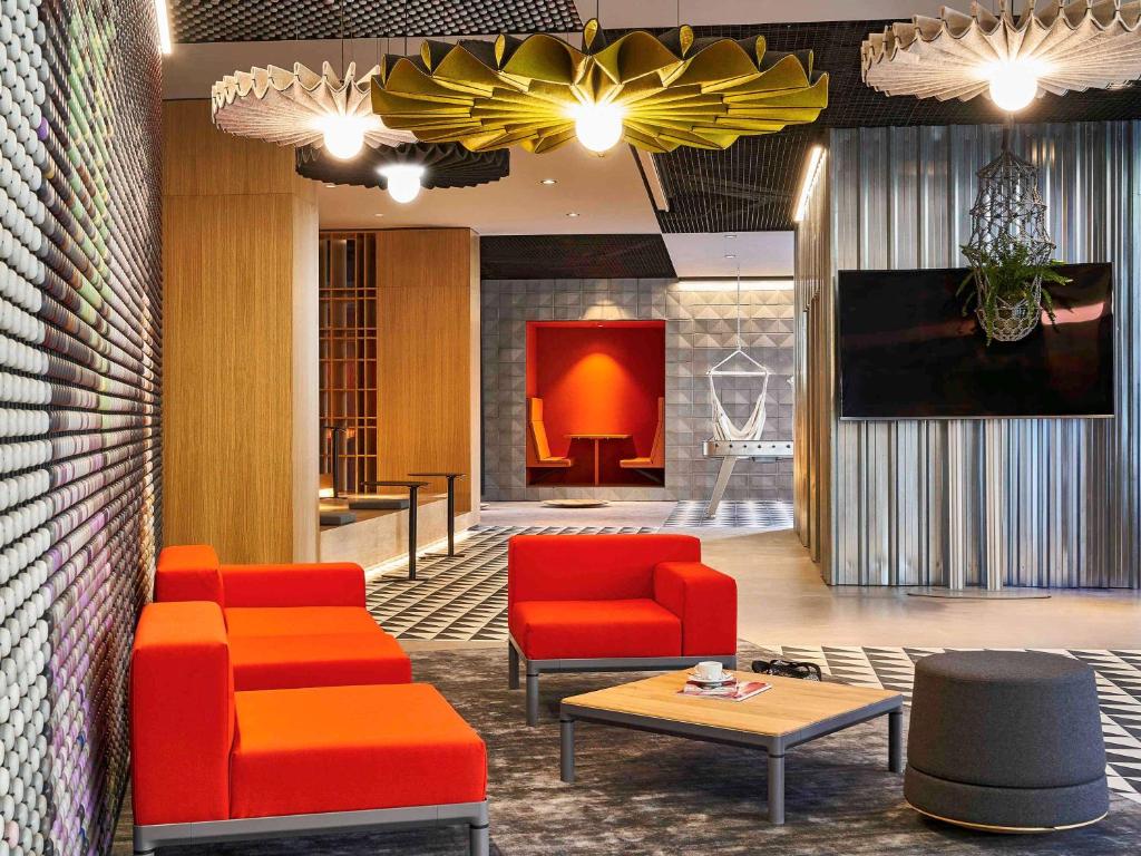 
a living room filled with furniture and a fire place at Ibis Barcelona Plaza Glòries 22@ in Barcelona
