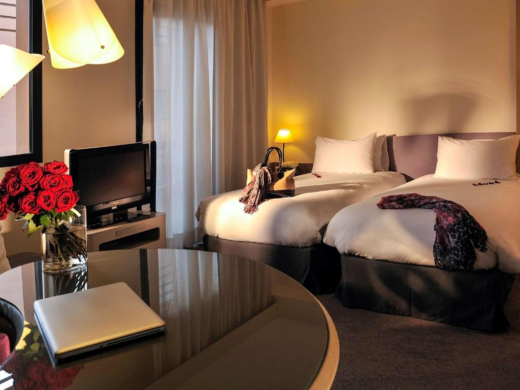 Postel nebo postele na pokoji v ubytování Novotel Marrakech Hivernage