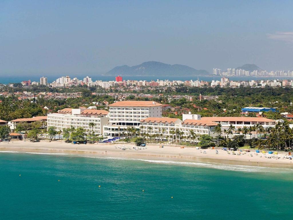 a view of a beach with buildings and the ocean at Hotel Jequitimar Guaruja Resort & Spa by Accor - Ex Sofitel in Guarujá