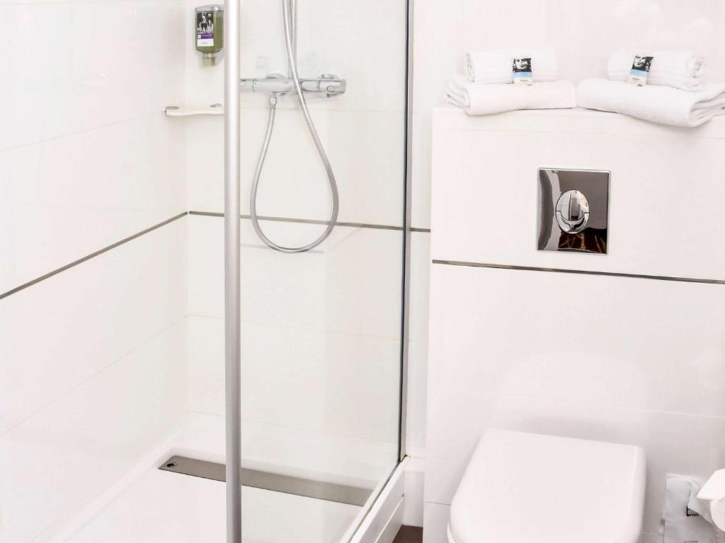 a bathroom with a shower with a toilet at Mercure Granville Le Grand Large in Granville