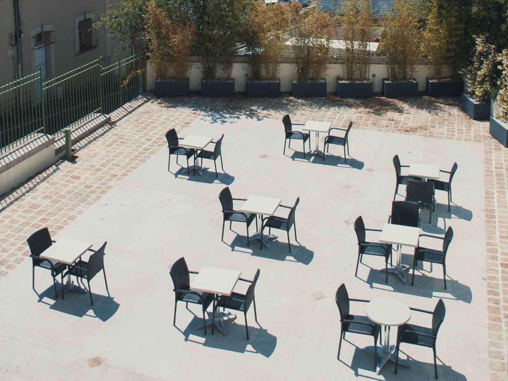 a group of tables and chairs on a patio at Mercure Granville Le Grand Large in Granville