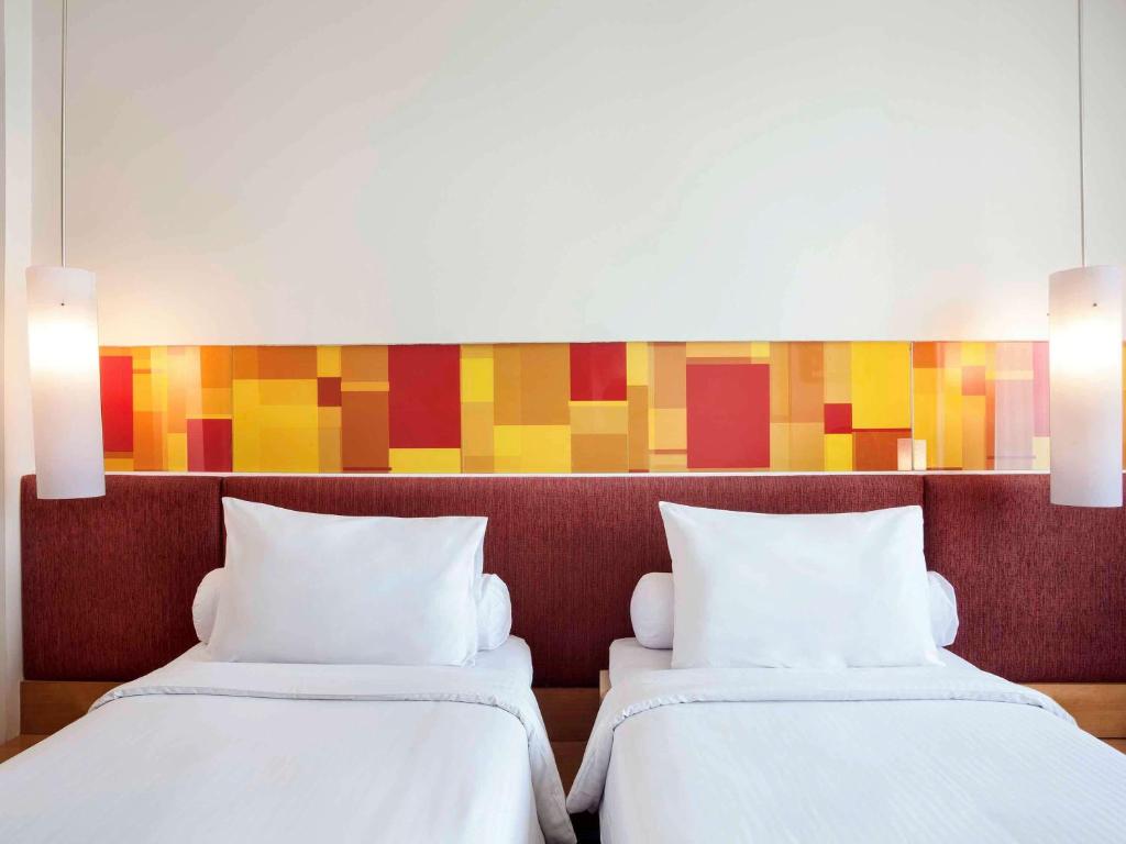 Postel nebo postele na pokoji v ubytování Ibis Styles Solo
