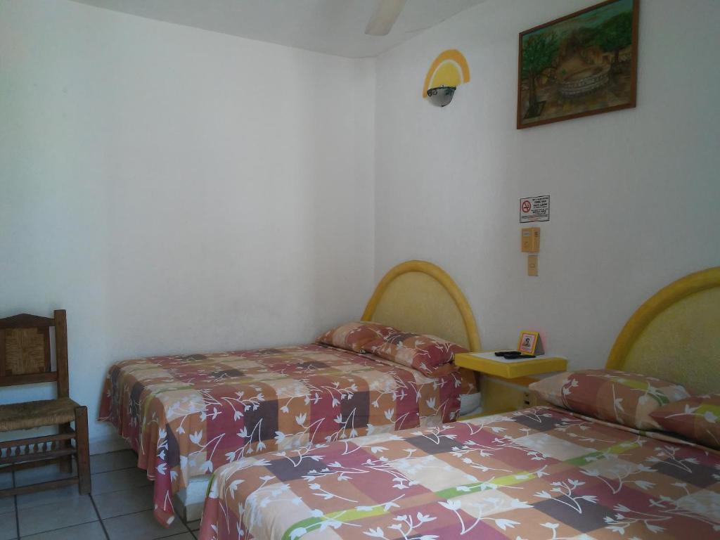 Postel nebo postele na pokoji v ubytování Hotel Sarabi