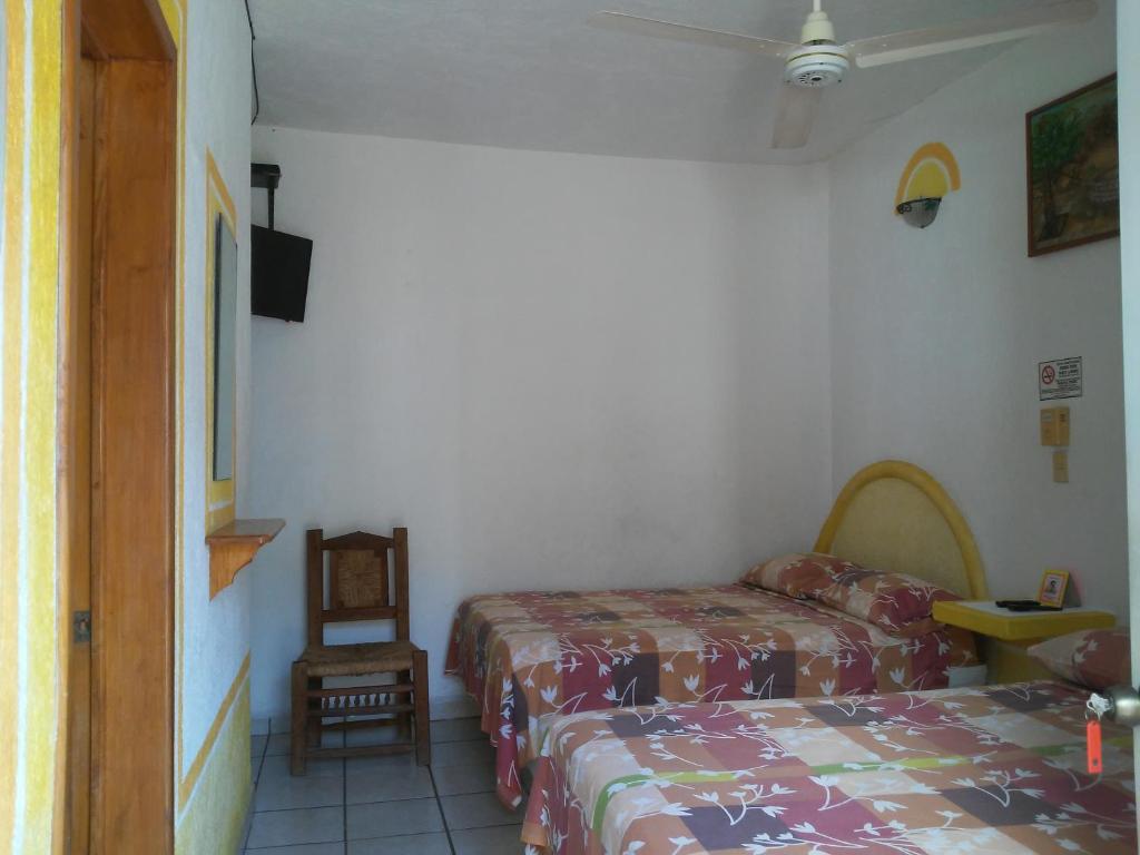 Postel nebo postele na pokoji v ubytování Hotel Sarabi