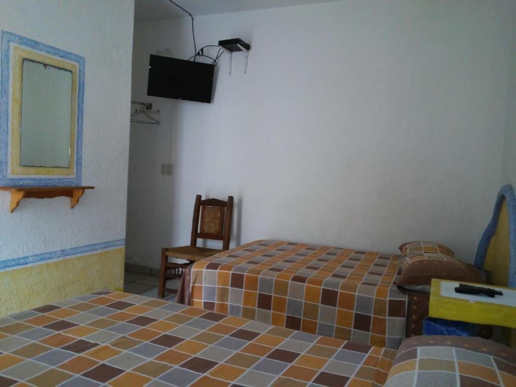 Postel nebo postele na pokoji v ubytování Hotel Sarabi