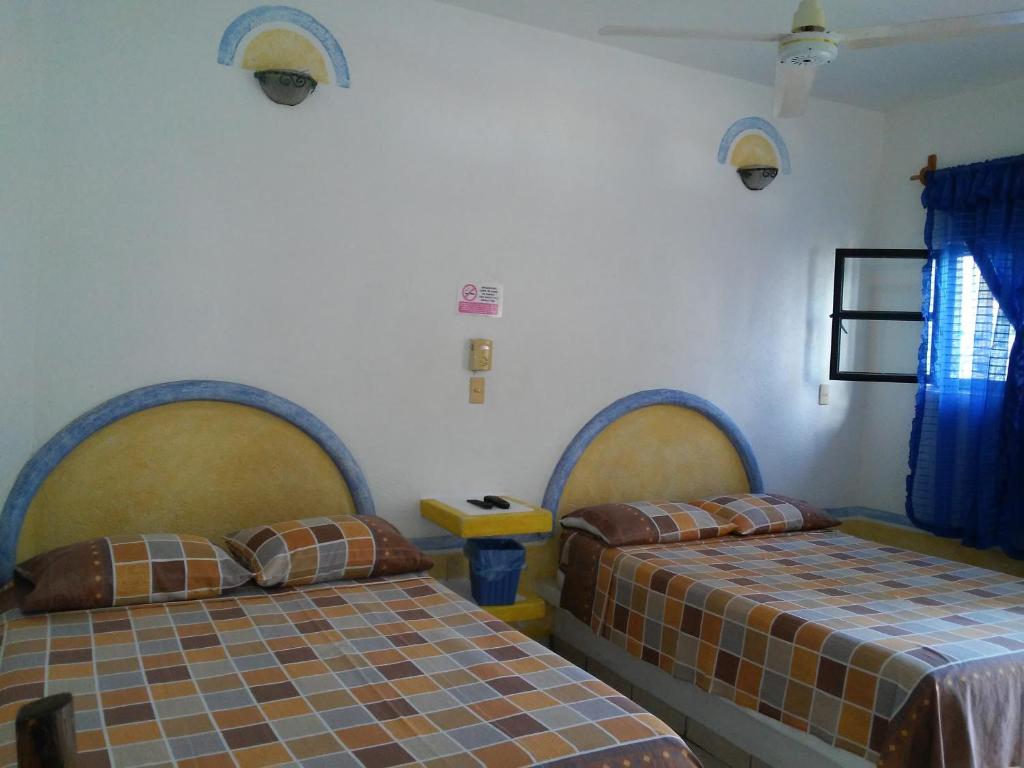 Postel nebo postele na pokoji v ubytování Hotel Sarabi