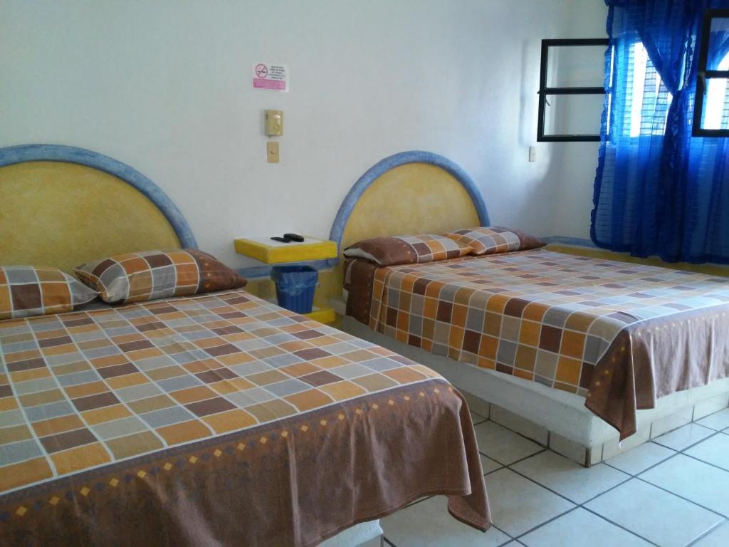 Postel nebo postele na pokoji v ubytování Hotel Sarabi