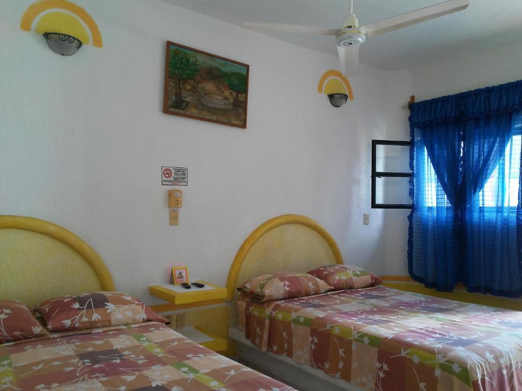 Postel nebo postele na pokoji v ubytování Hotel Sarabi