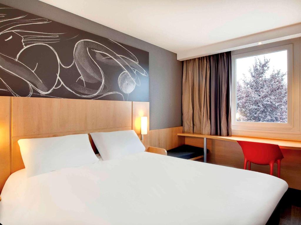 Postel nebo postele na pokoji v ubytování ibis Clermont Ferrand Nord Riom