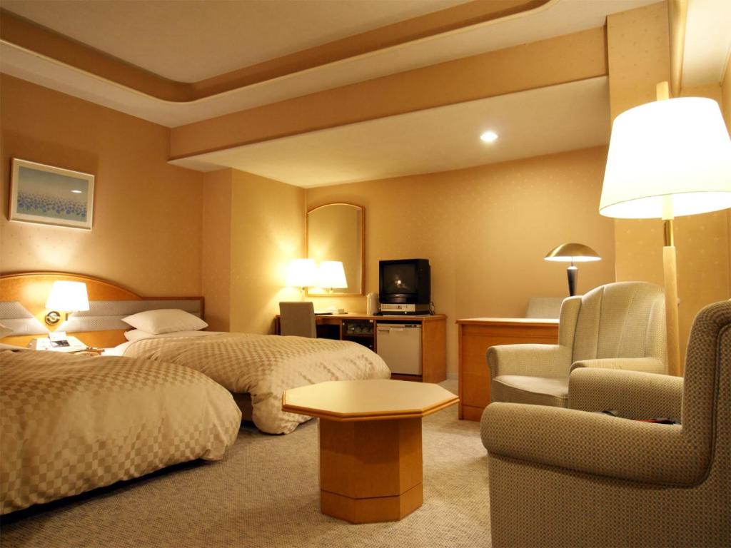 Postel nebo postele na pokoji v ubytování Palace Hotel Kakegawa