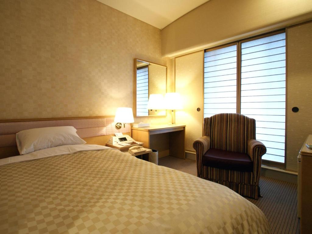 Postel nebo postele na pokoji v ubytování Palace Hotel Kakegawa