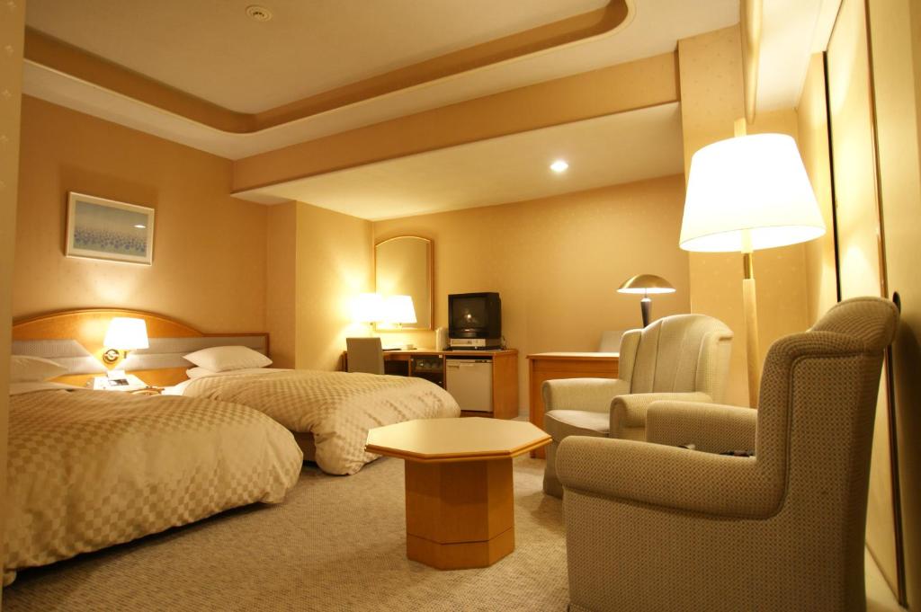 Postel nebo postele na pokoji v ubytování Palace Hotel Kakegawa