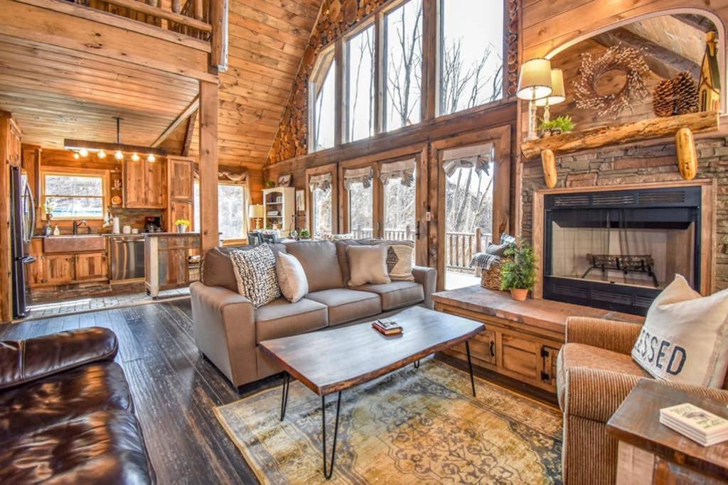 a living room with a couch and a fireplace at Bear Sightings! 8 mins to downtown Gatlinburg, Kids Cave, Theatre, Treehouse! in Gatlinburg