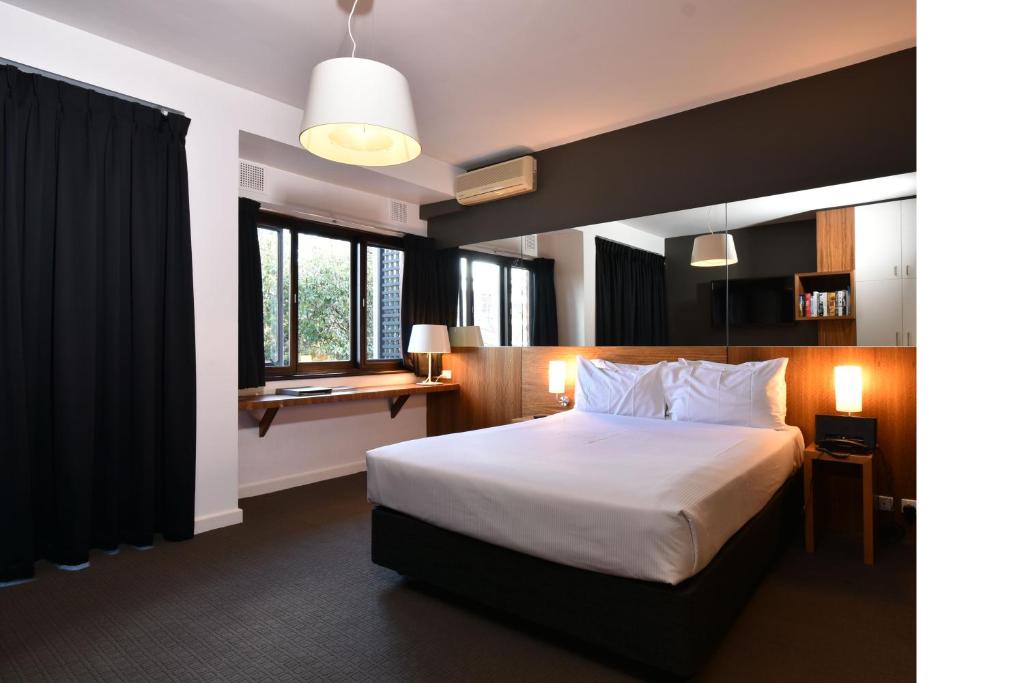 a hotel room with a bed and a window at Riverview on Mount Street in Perth
