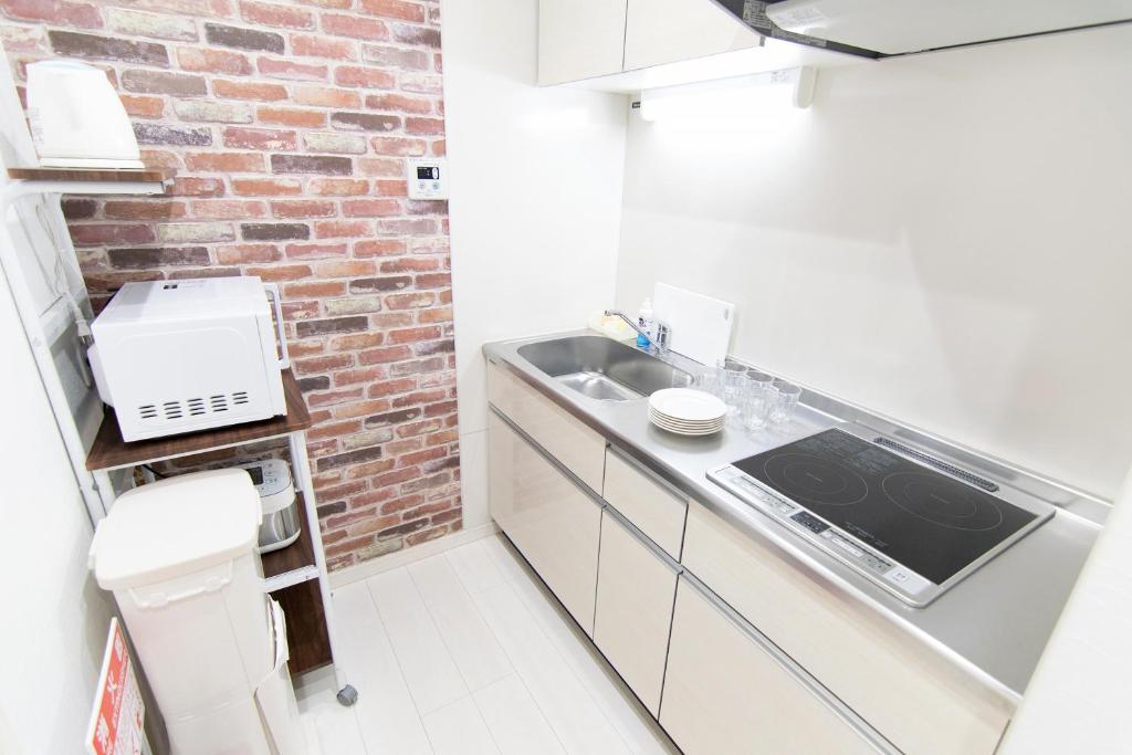 Kuchyň nebo kuchyňský kout v ubytování RUMa INN Rokugoudote