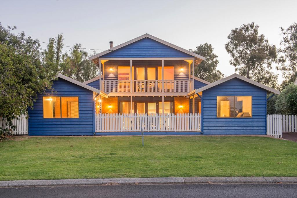 a blue house with a balcony on a yard at Ultramarine in Dunsborough