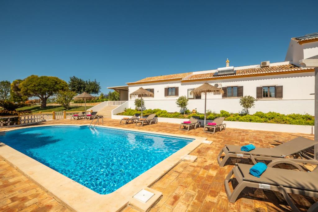 a villa with a swimming pool and a house at Casa Katarina - Private Villa - Heated pool - Free Wifi - Air Con in Tunes