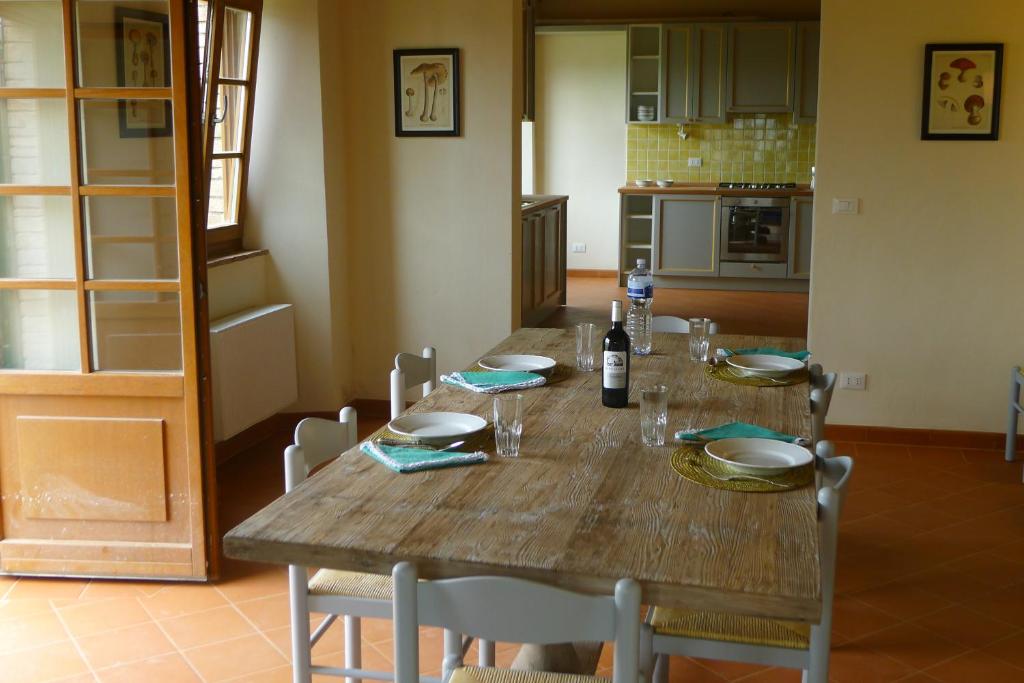 - une table en bois dans la cuisine avec une table et des chaises dans l'établissement Podere San Giuseppe Maremma, à Castelnuovo di Val di Cecina