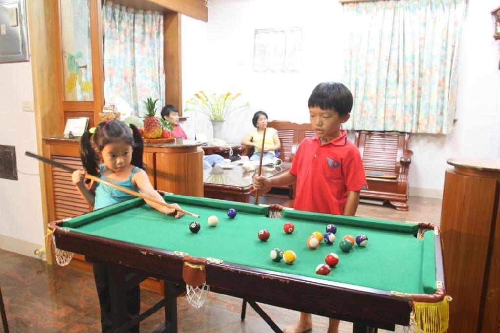 two children playing pool with a pool table at Yilan Affectivity in Wujie