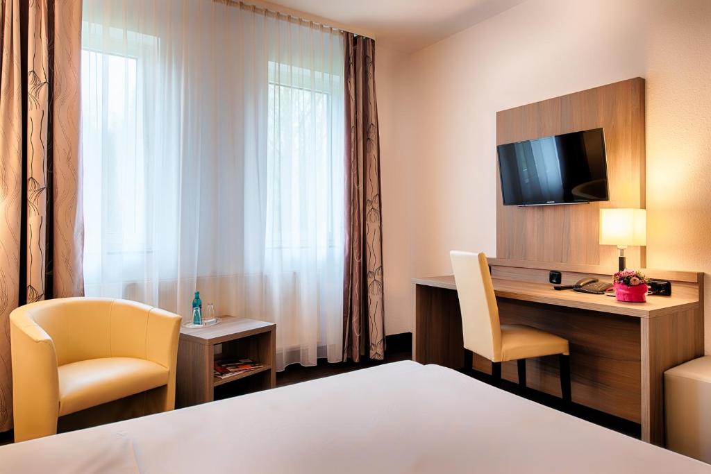 Postel nebo postele na pokoji v ubytování ACHAT Hotel Bochum Dortmund