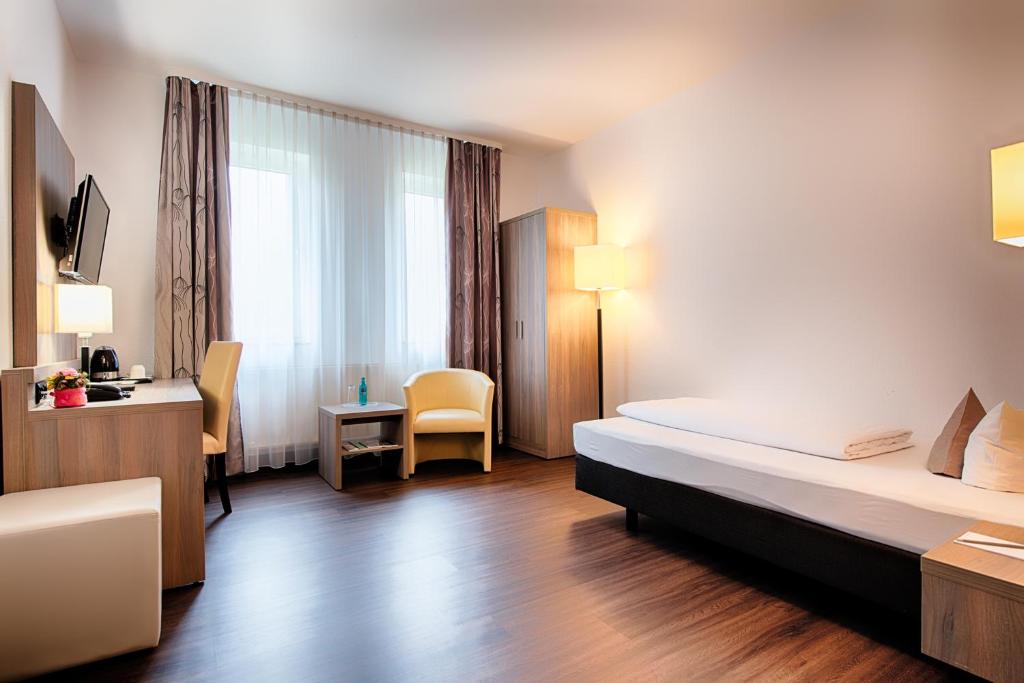 Postel nebo postele na pokoji v ubytování ACHAT Hotel Bochum Dortmund
