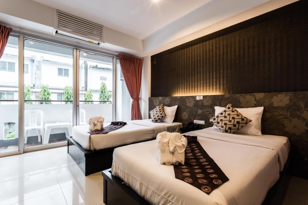 Postel nebo postele na pokoji v ubytování 7Q Patong Beach Hotel