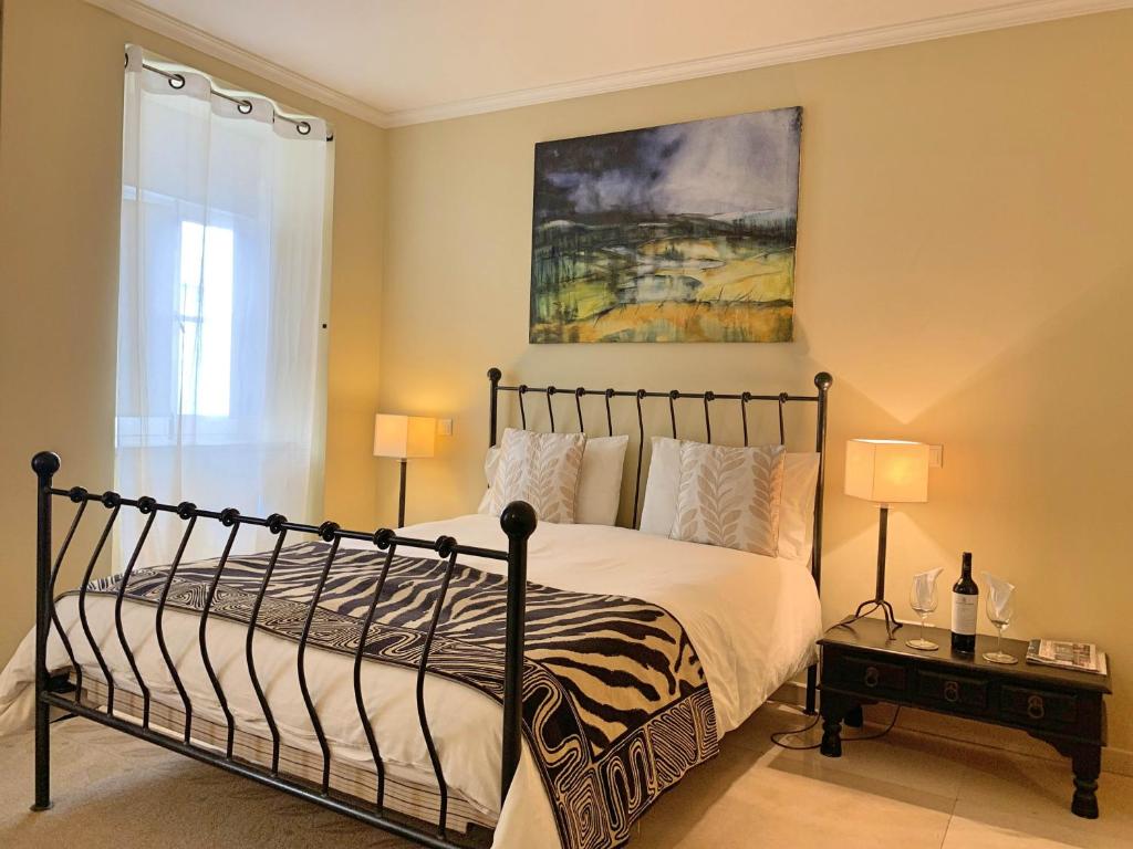 a bedroom with a bed and a painting on the wall at Residence Lagos in Lagos