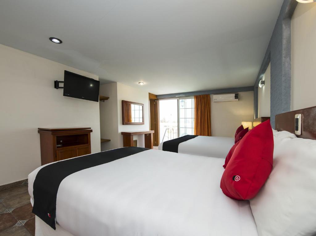 Postel nebo postele na pokoji v ubytování Suites de Reyes