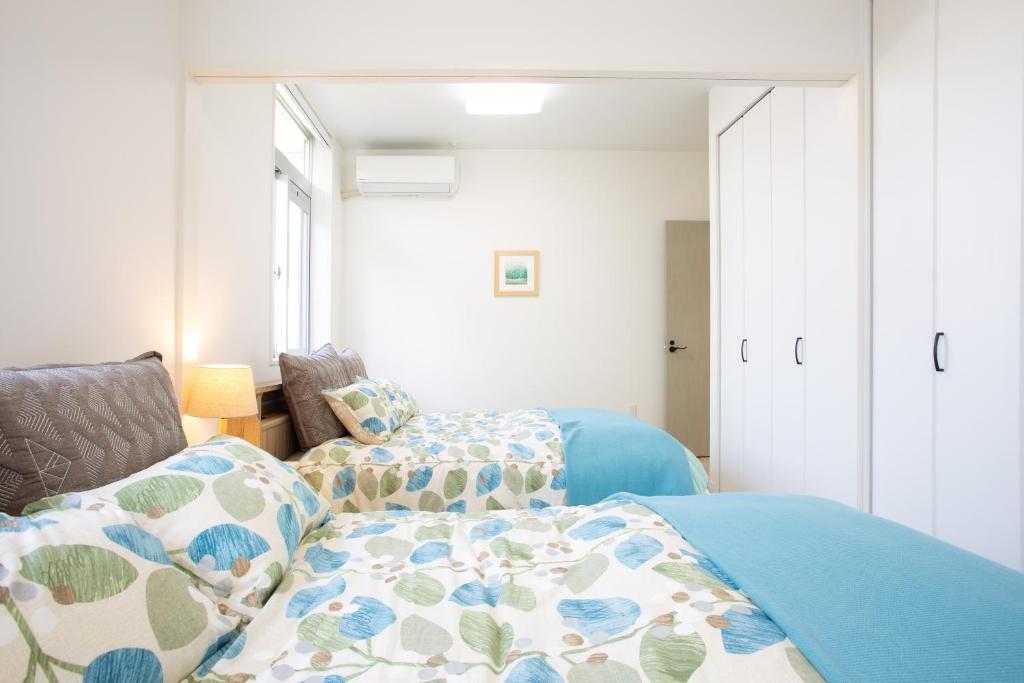 Postel nebo postele na pokoji v ubytování stylish House URUMA