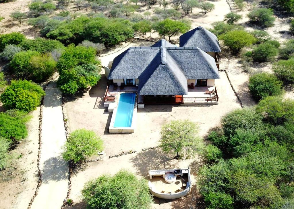 an aerial view of a house with a swimming pool at Beautiful Mountain Views From A 2-Bedroom Home With Pool in Hoedspruit