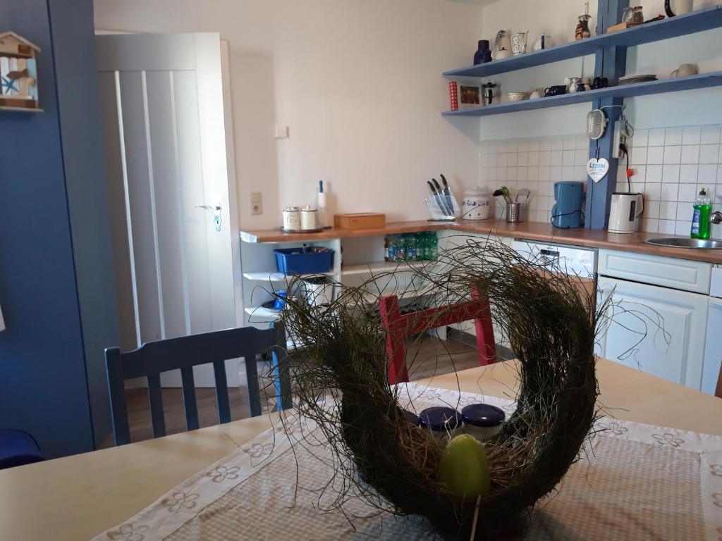 a kitchen with a table with a nest on it at Zum Storchennest in Kemnitz