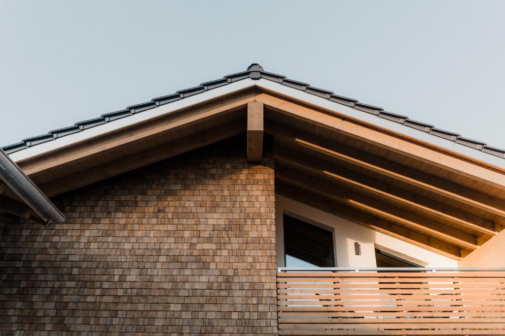 a roof of a brick house with a window at Allgäu-Chalets-Niso in Waltenhofen