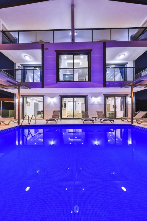 a swimming pool in front of a building at Villa Kas Bohem in Kaş