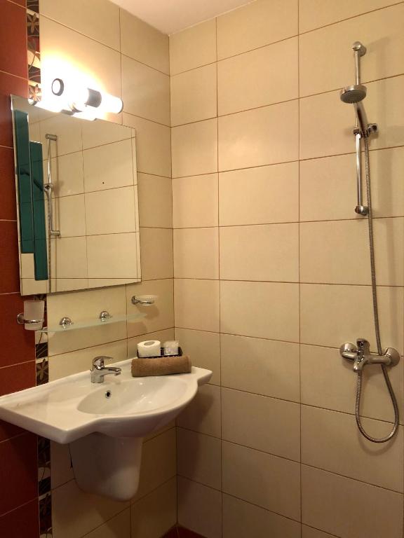 a bathroom with a sink and a mirror at Hotel Silver in Sozopol