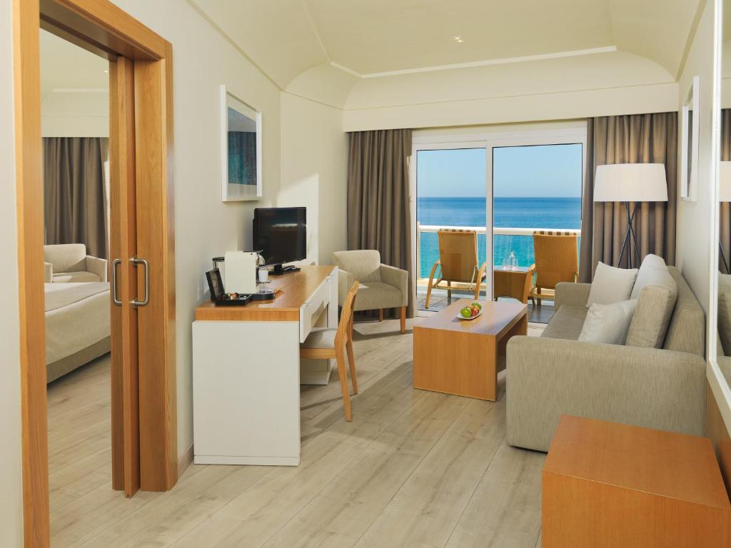 a hotel room with a living room with a view of the ocean at XQ El Palacete in Morro del Jable
