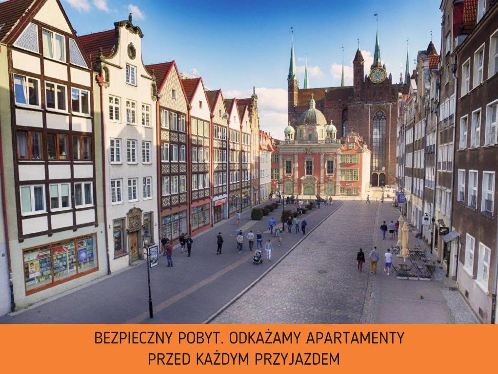 a city street with buildings and people walking on the street at Apartament Old City Center Gdańsk by Renters in Gdańsk