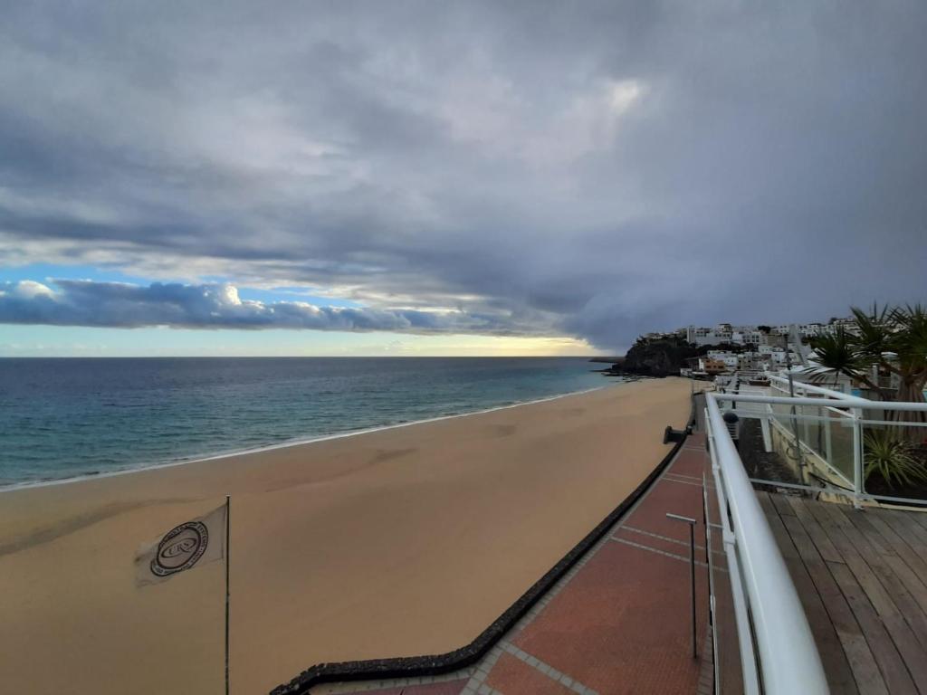 a view of the beach from the balcony of a building at XQ El Palacete in Morro del Jable