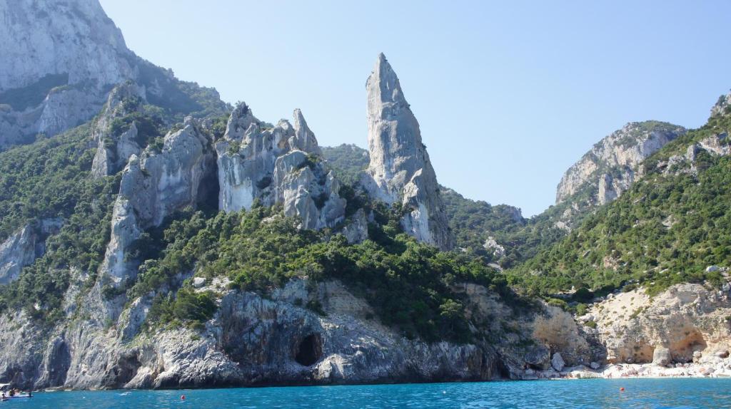 a mountain with a tunnel in the middle of the water at Casa Turusele in Santa Maria Navarrese
