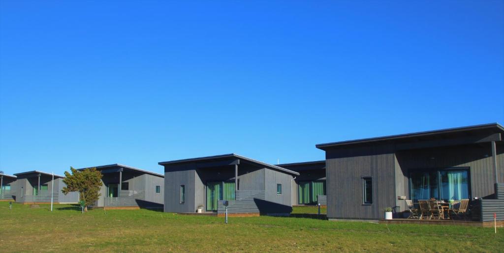 a row of modular homes in a field at Tofta Resort in Tofta