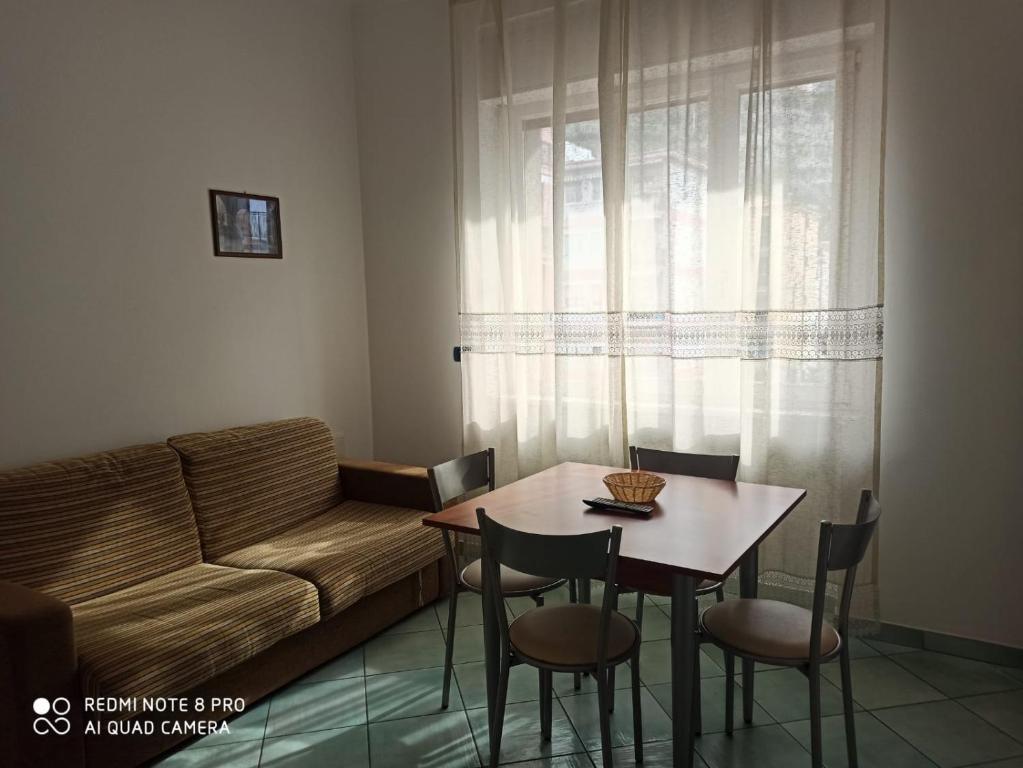 a living room with a couch and a table and chairs at La Residenza Aparthotel in Maiori