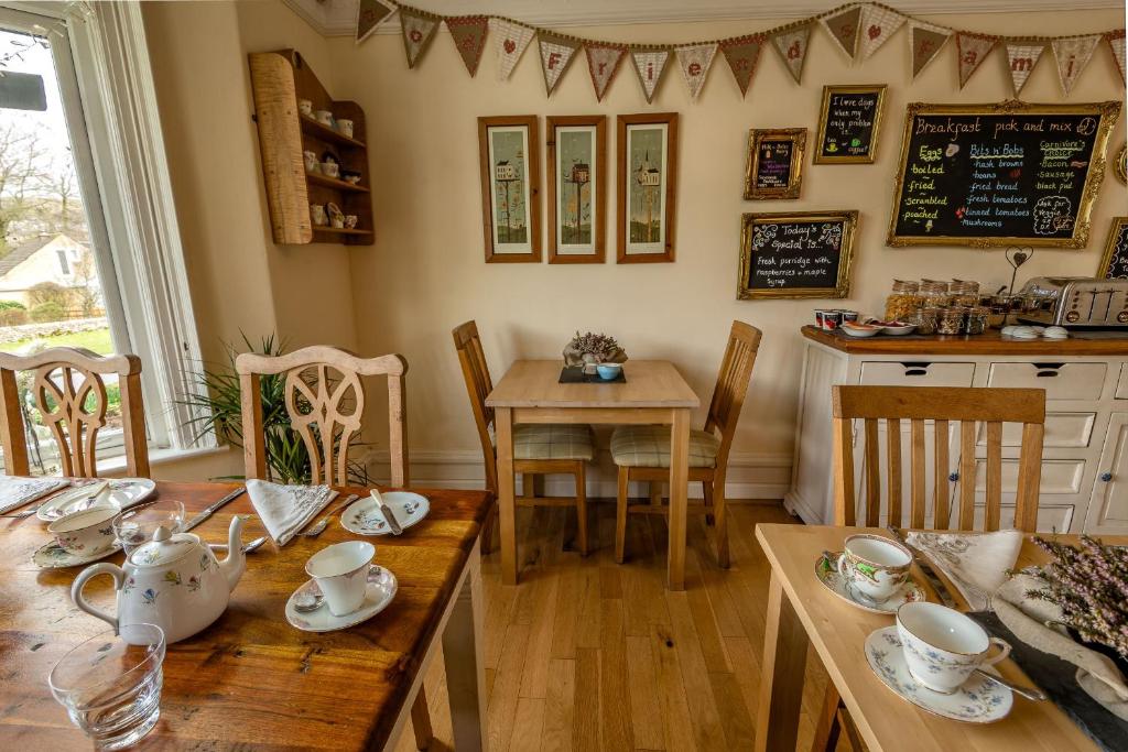 a dining room with a wooden table and chairs at Craiglands Bed and Breakfast, Grassington in Grassington