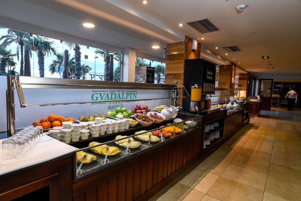 a buffet line in a hotel with food on display at Gran Hotel Guadalpín Banus in Marbella
