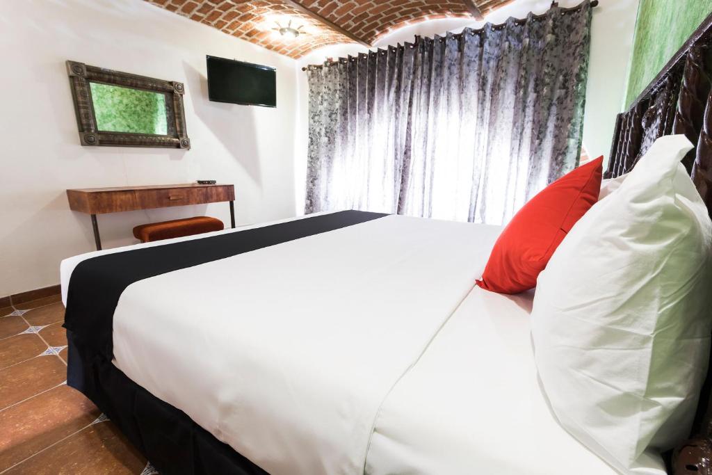 Postel nebo postele na pokoji v ubytování Hotel Hacienda Tonalmain, Central Nueva
