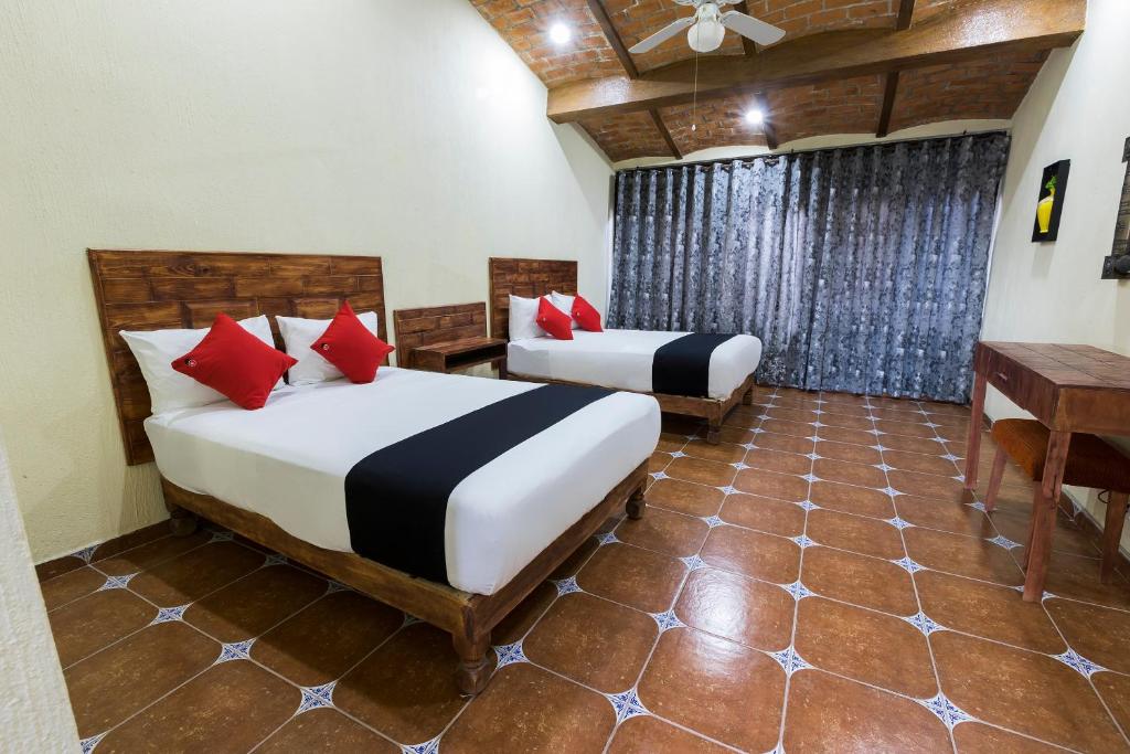 Postel nebo postele na pokoji v ubytování Hotel Hacienda Tonalmain, Central Nueva