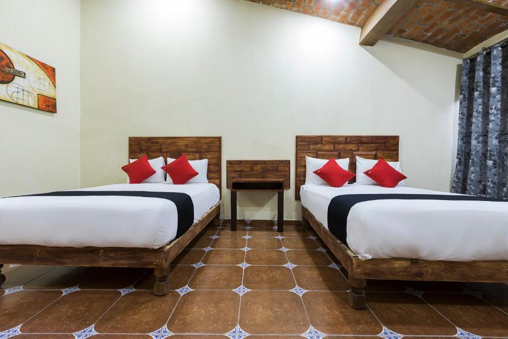 Postel nebo postele na pokoji v ubytování Hotel Hacienda Tonalmain, Central Nueva